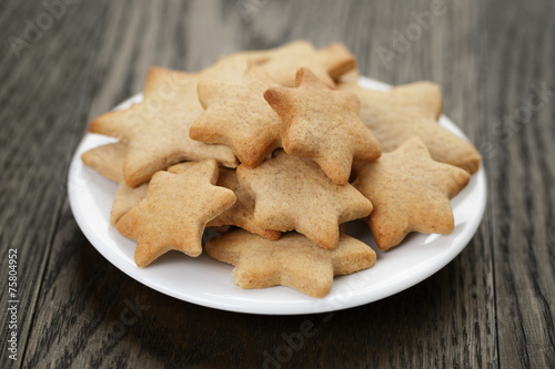 homemade star shape ginger cookies on wood table