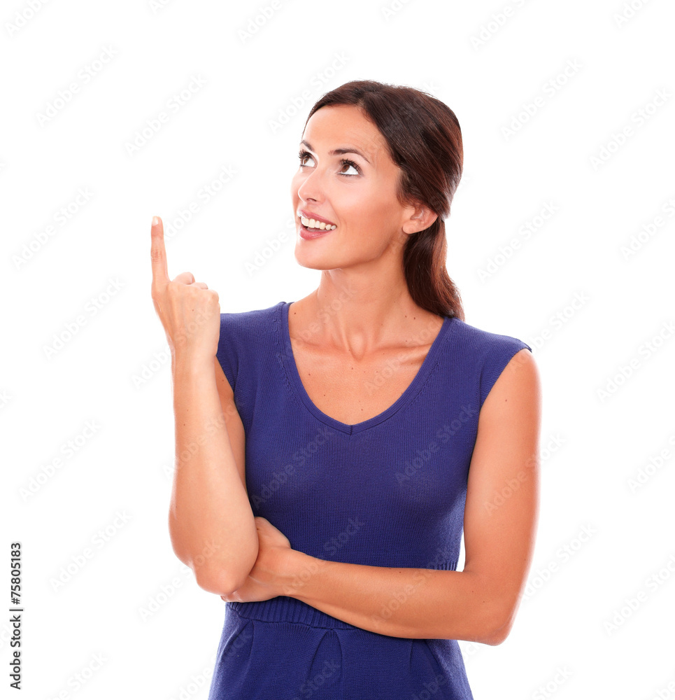 Fashionable latin lady pointing up smiling Fashionable latin lady pointing up smiling