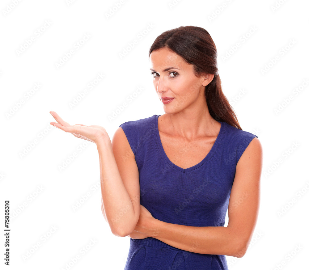 Brunette lady in purple dress holding palm up Brunette lady in purple dress holding palm up