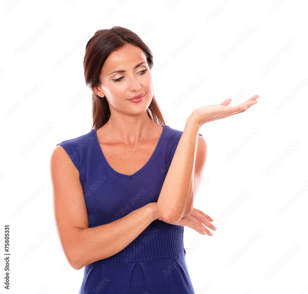 Attractive woman in purple dress holding palm up Attractive woman in purple dress holding palm up