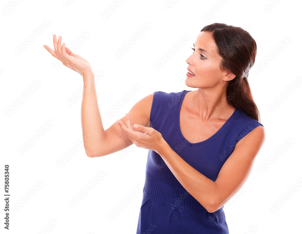 Pretty young lady in purple dress holding palm up Pretty young lady in purple dress holding palm up