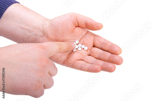 Hand holding pills. Isolated on white background