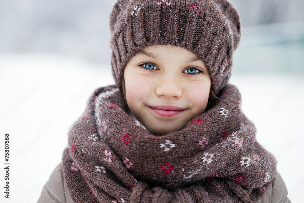 Happy little girl on the background of a winter park Happy little girl on the background of a winter park