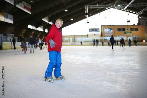 Happy school boy having fun at indoors skating rink © cromary