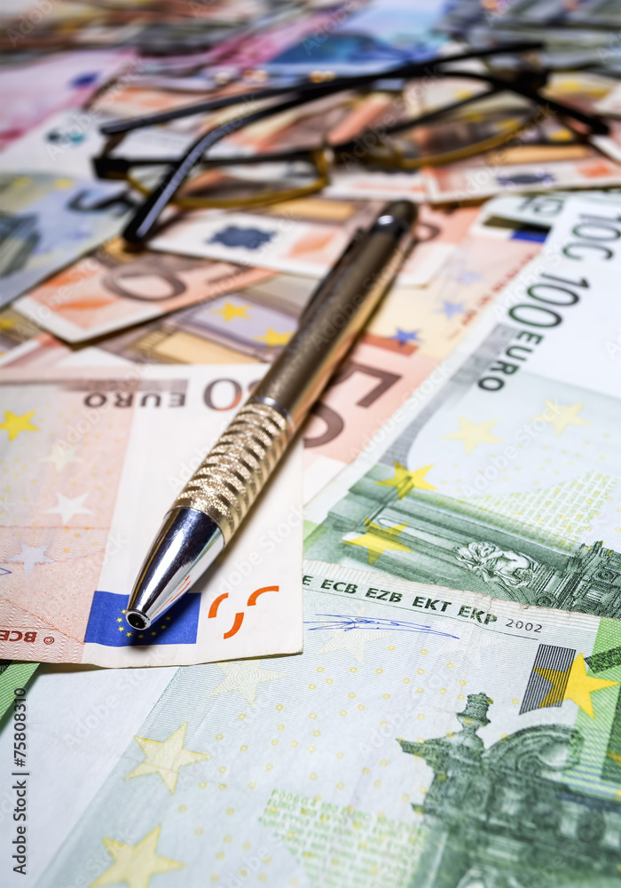 Pen with euro banknotes.