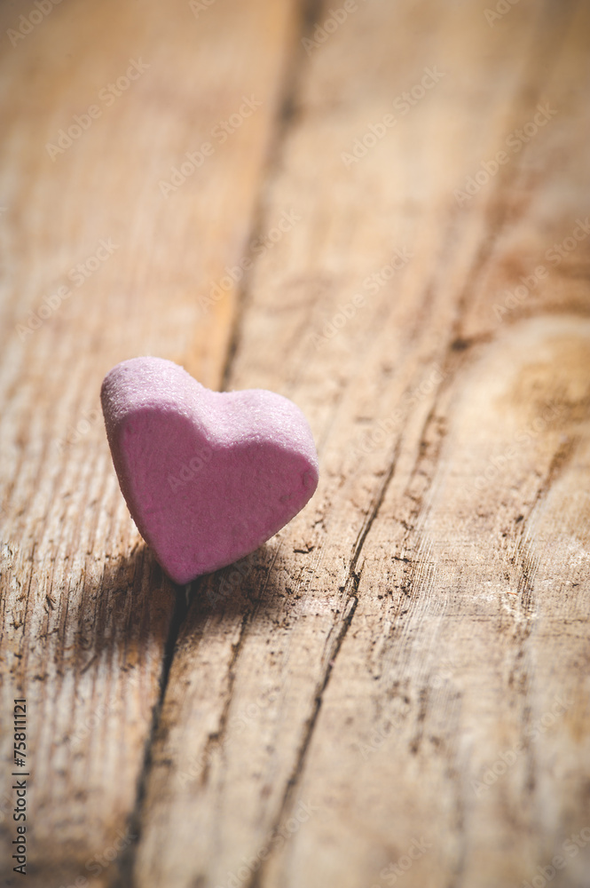 Fototapeta premium The pink heart on a wooden rustic table as background