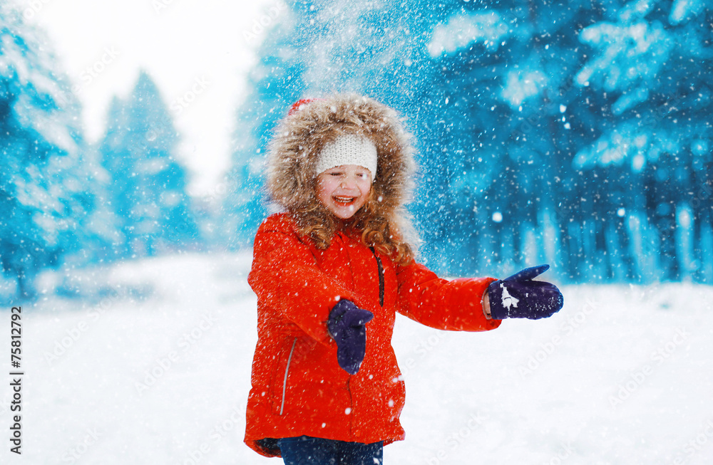 Cheerful child having fun outdoors with snowball in winter snowy Cheerful child having fun outdoors with snowball in winter snowy