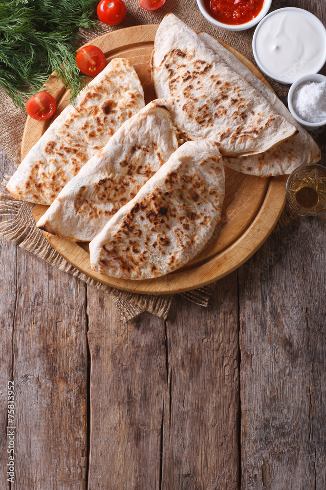 Fototapeta premium Quesadilla with vegetables and sauces vertical top view