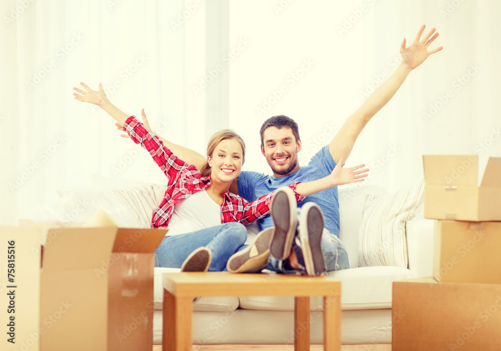 smiling couple relaxing on sofa in new home smiling couple relaxing on sofa in new home