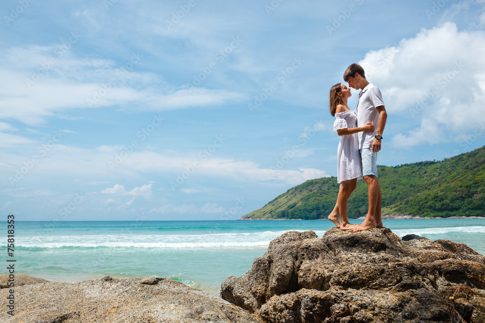 lovely young adult couple standing on the rocks lovely young adult couple standing on the rocks