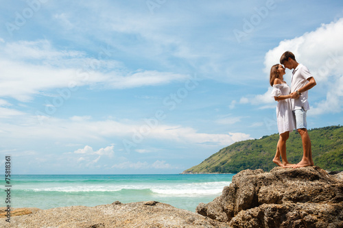 lovely young adult couple standing on the rocks © chesterF