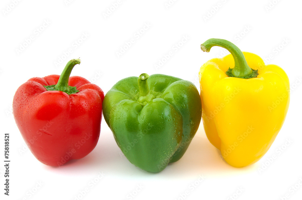 Close up of green, red and yellow fresh peppers on white