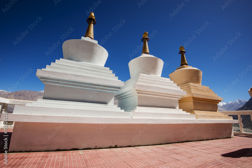 Three stupa and blue sky at Diskit monastery, Ladakh