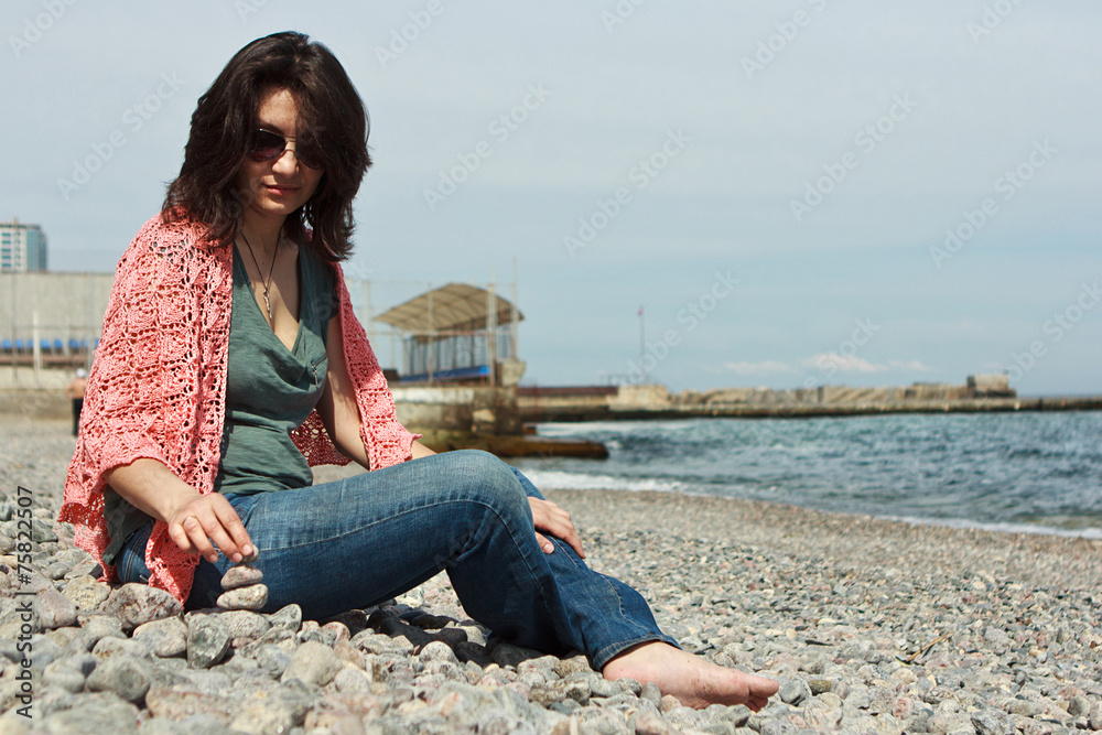 Young woman resting on sea beach