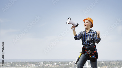 Woman builder with megaphone