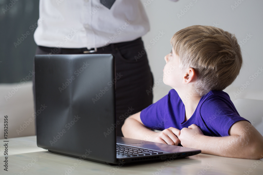 Child using father's laptop Child using father's laptop