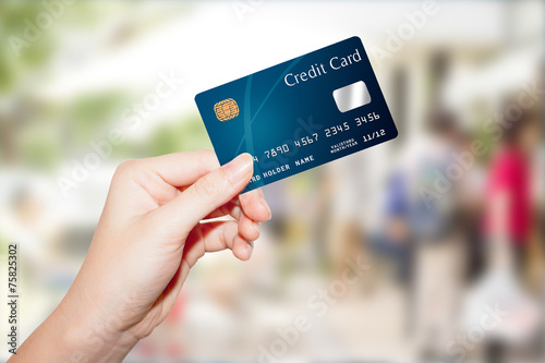 female hand holding credit card