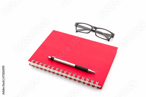 Red Diary Book with old glasses and pen.