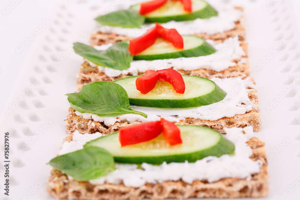 Cracker with fresh vegetables and cream
