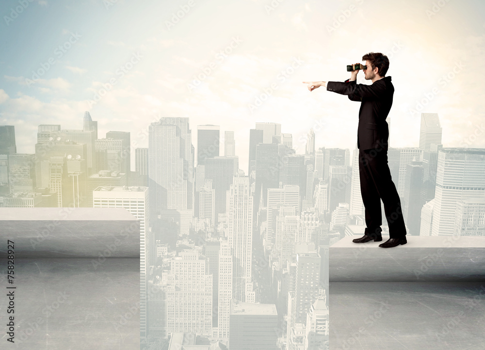 Businessman standing on the edge of rooftop Businessman standing on the edge of rooftop