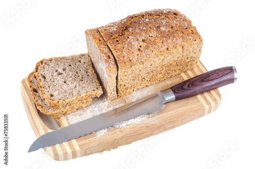 Cut wholemeal bread and knife on a chopping board