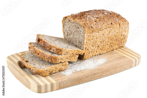 Cut wholemeal bread on a chopping board photo