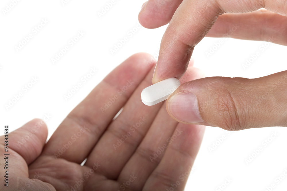 Hand giving a pill Hand giving a pill