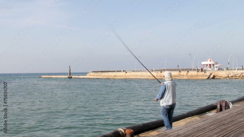 Old fisherman in the old port in the southern Mediterranean sea Old fisherman in the old port in the southern Mediterranean sea