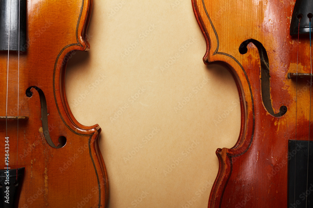 Fototapeta premium Two grunge old violin on vintage yellowed paper