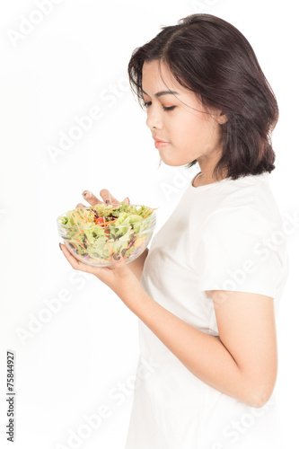 Pretty girl eating fresh vegetable salad