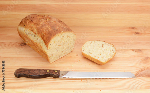 Bread knife with freshly sliced loaf of bread