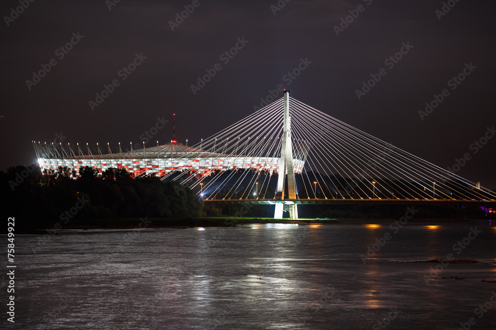 Night view of bridge and stadium in Warsaw - obrazy, fototapety, plakaty 