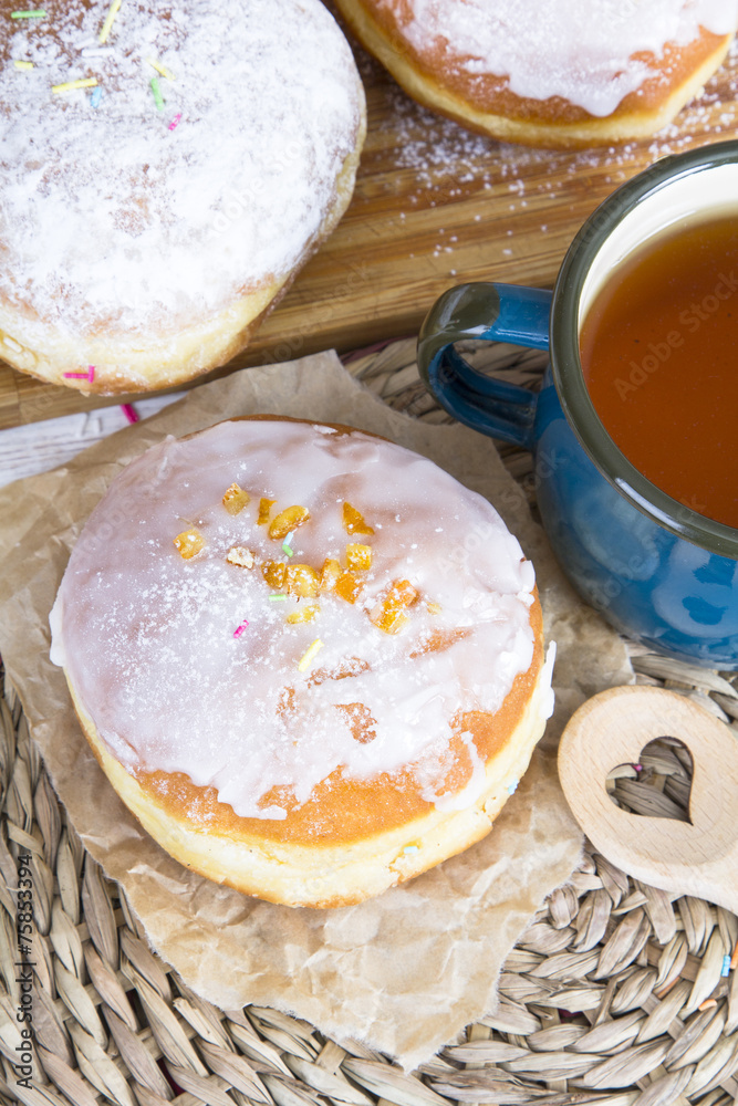 Classic glazed doughnuts and mug of tea Classic glazed doughnuts and mug of tea