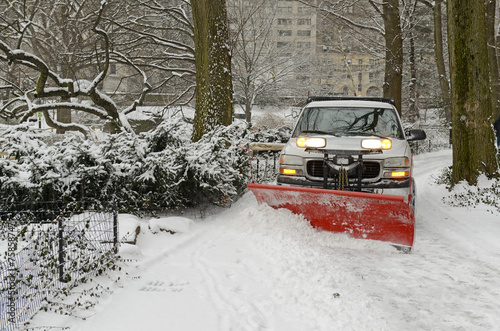 Картината върху платно Truck plowing snowy road after snowstorm