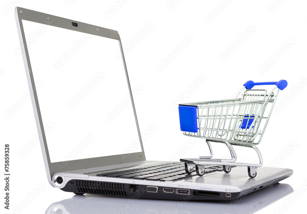 Shopping cart over a laptop computer, isolated on white backgrou