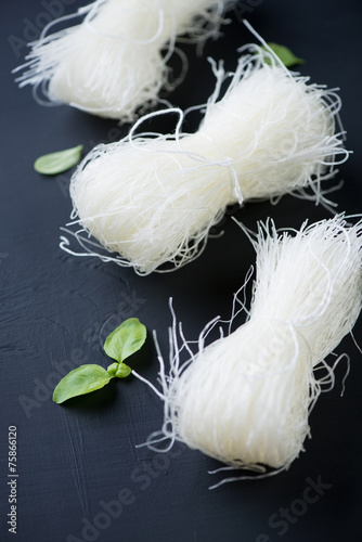 Close-up of raw bean vermicelli over black wooden background