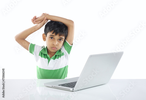 Depressed Indian School Boy with Laptop © V.R.Murralinath