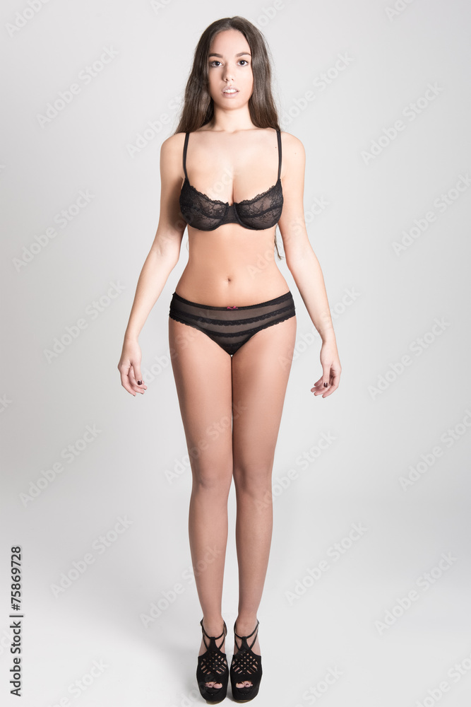 Woman with long hair in lingerie on white background