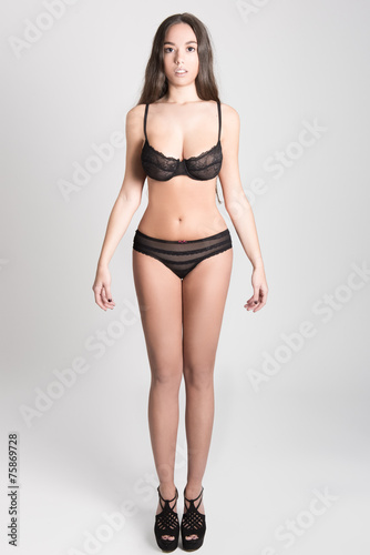 Woman with long hair in lingerie on white background