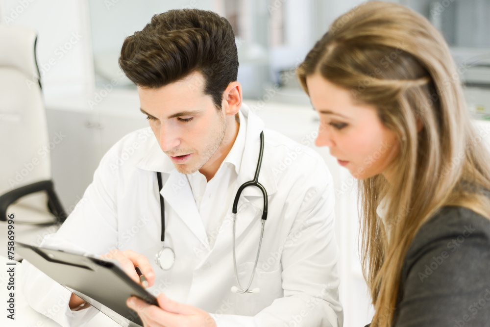 Doctor explaining diagnosis to her female patient Doctor explaining diagnosis to her female patient