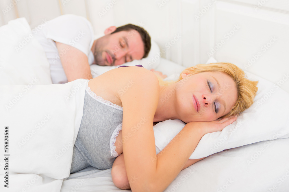Young attractive couple sleeping in a bed Young attractive couple sleeping in a bed