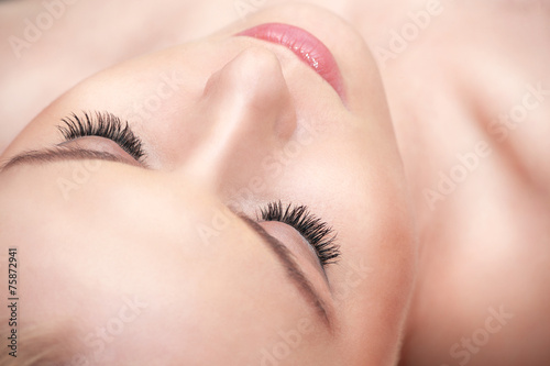 Lying woman eyes with long eyelashes.