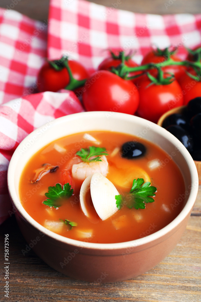 Tasty soup with shrimps, mussels, tomatoes and black olives in Tasty soup with shrimps, mussels, tomatoes and black olives in