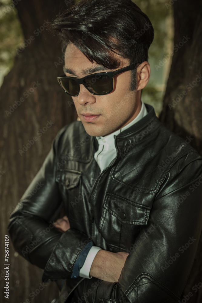 Pensive young fashion man holding his hands crossed Pensive young fashion man holding his hands crossed