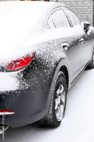 Black car covered with snow  outdoors