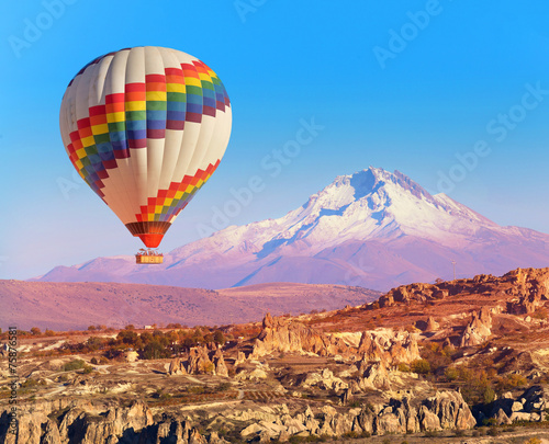 Balloon flying over rock landscape at Cappadocia Turkey
