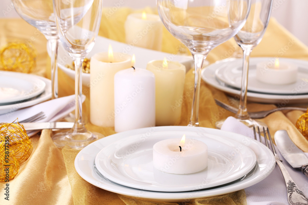 Beautiful holiday table setting in white and gold color