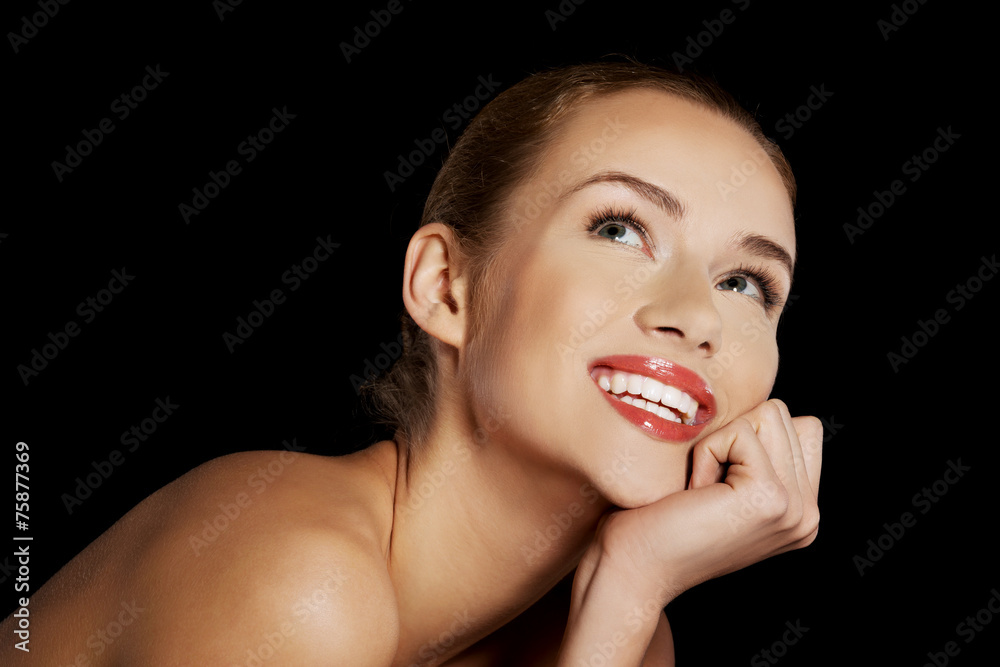 Portrait of smiling nude woman on dark background Portrait of smiling nude woman on dark background