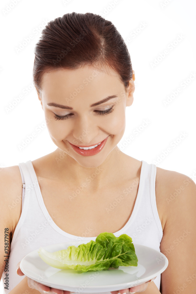 Portrait of a woman holding plate with lettuce Portrait of a woman holding plate with lettuce