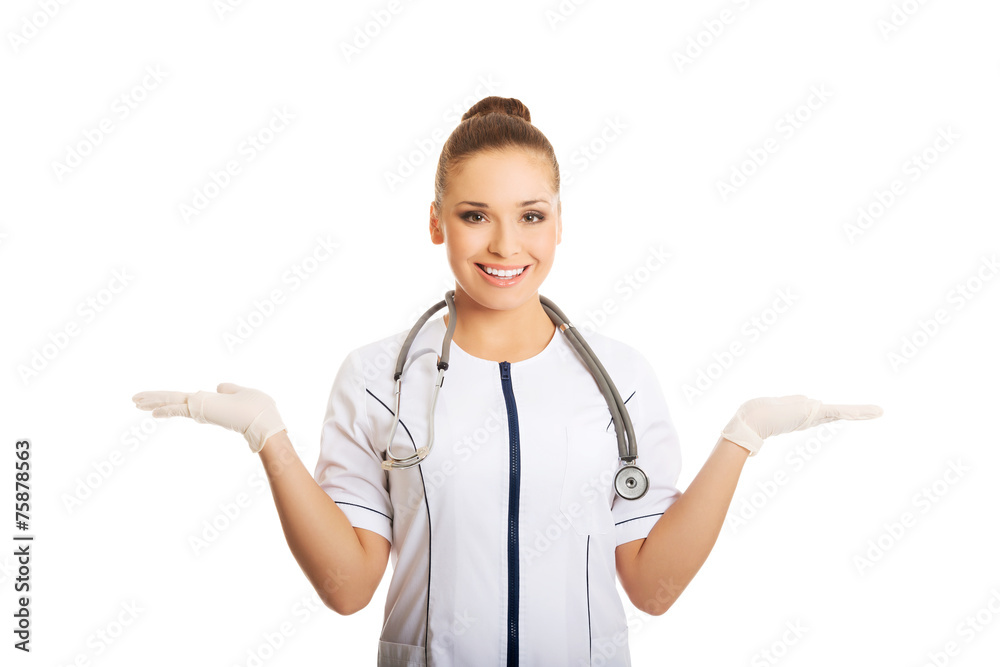 Female doctor presenting copyspace in hands Female doctor presenting copyspace in hands